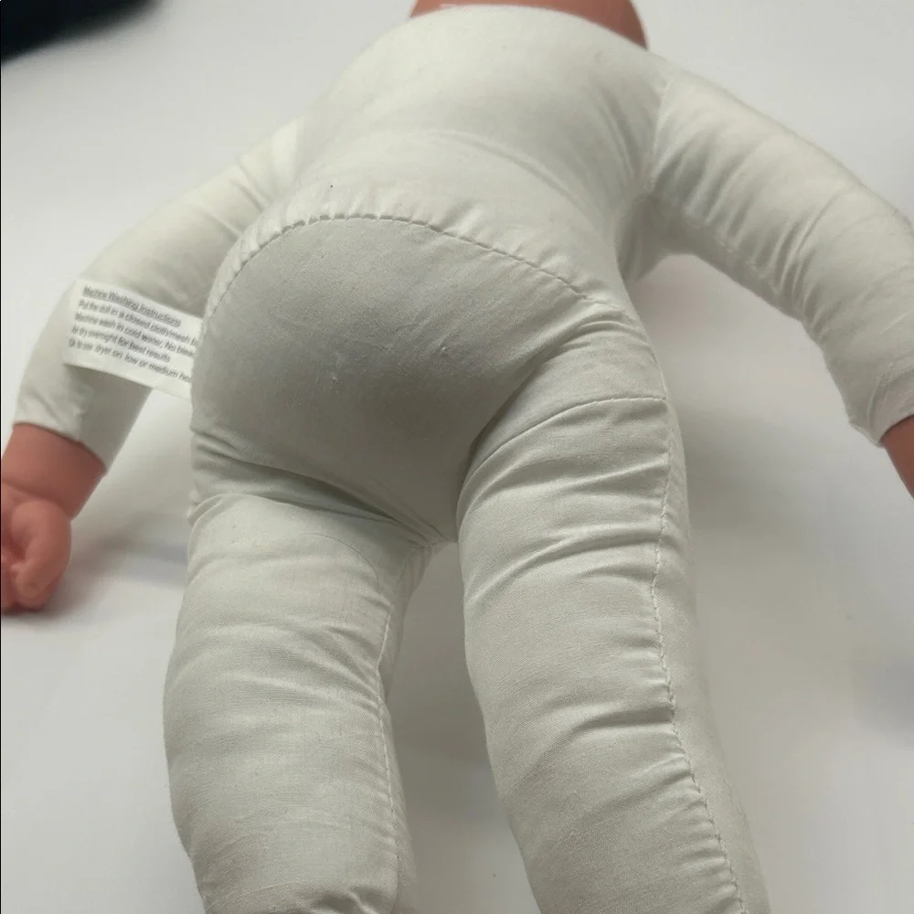 Realistic Baby Doll with White Outfit
